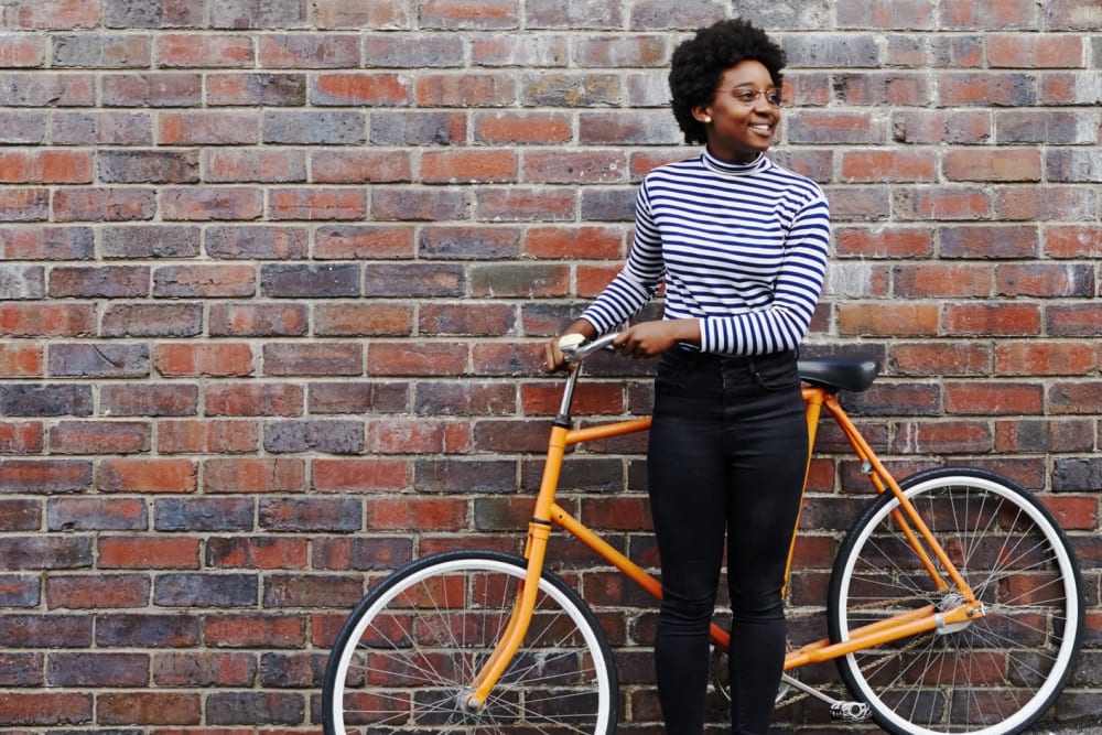 Resident riding bike near Huntcliffe Apartments in Fair Oaks, California